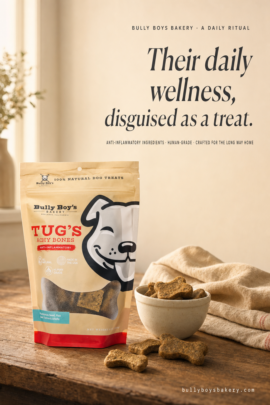 Tug's Achy Bones bag on wood kitchen counter with bowl, treats spilling out, morning light. Headline: Their daily wellness, disguised as a treat.